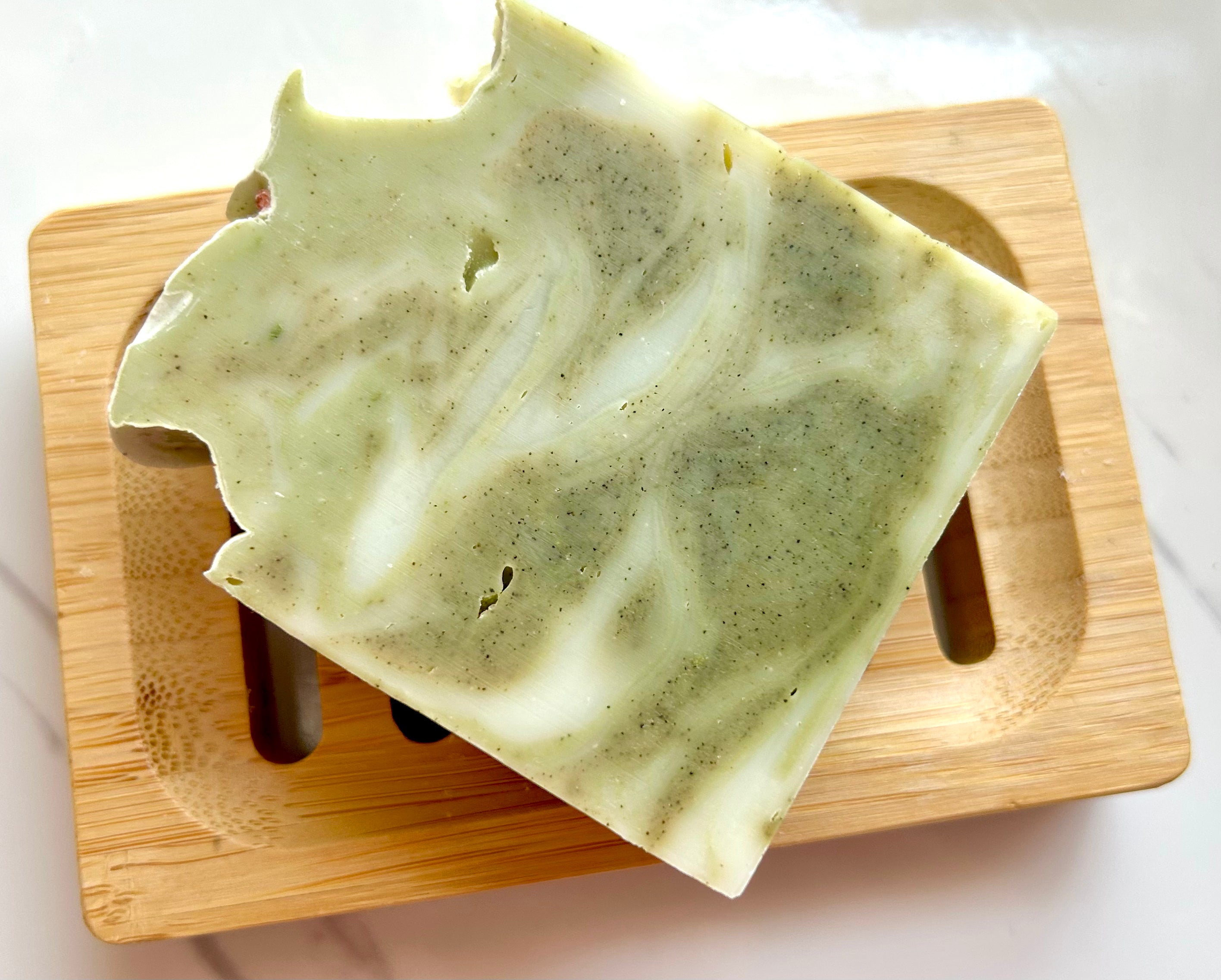 Coastal Drift - Lime, Lavender, Eucalyptus, Rosemary & Cedarwood (Water) Tallow Soap on a wooden soap dish.