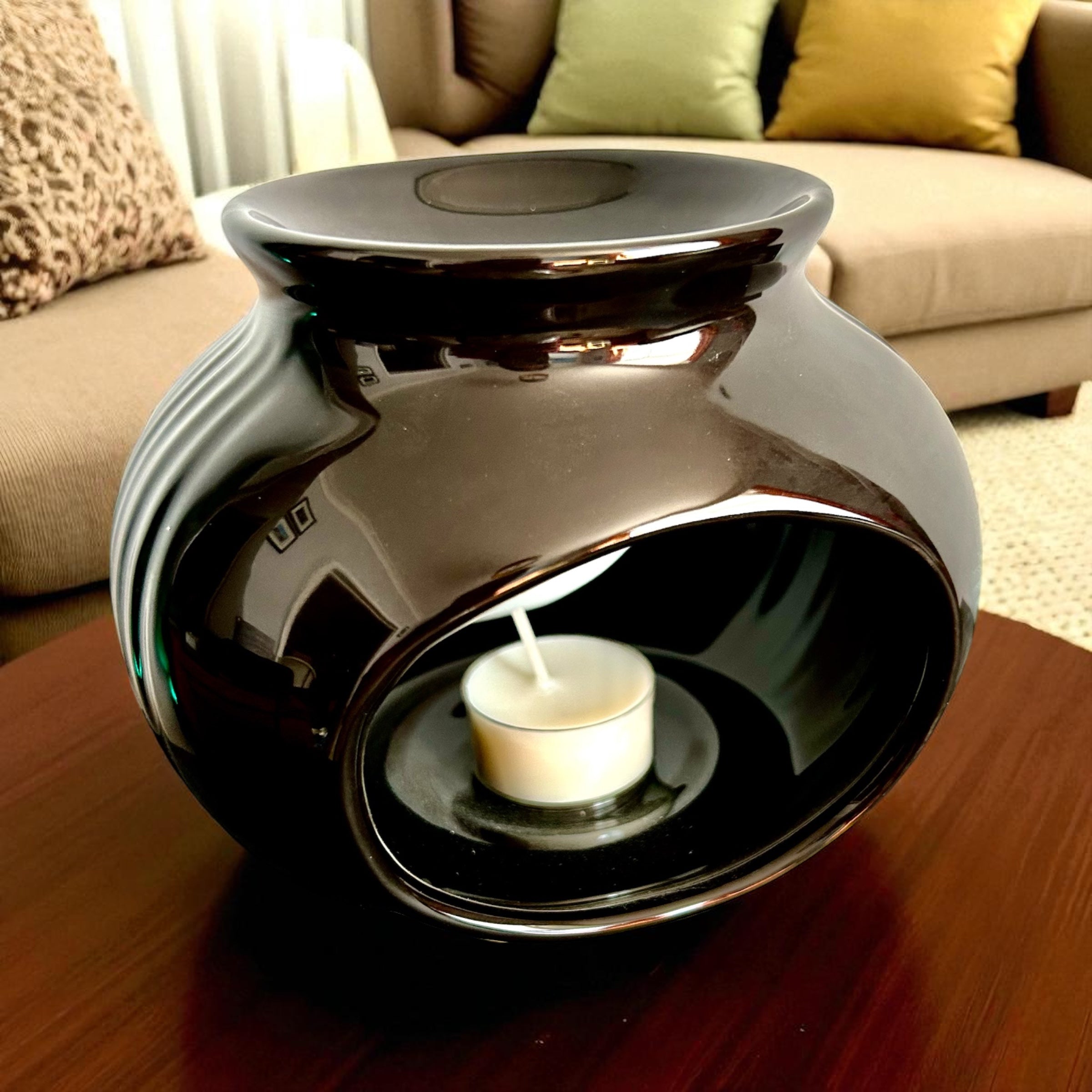 Shadowglow Wax Burner — Gloss Black Ceramic with a shallow top dish and an unlit tealight inside its oval opening.